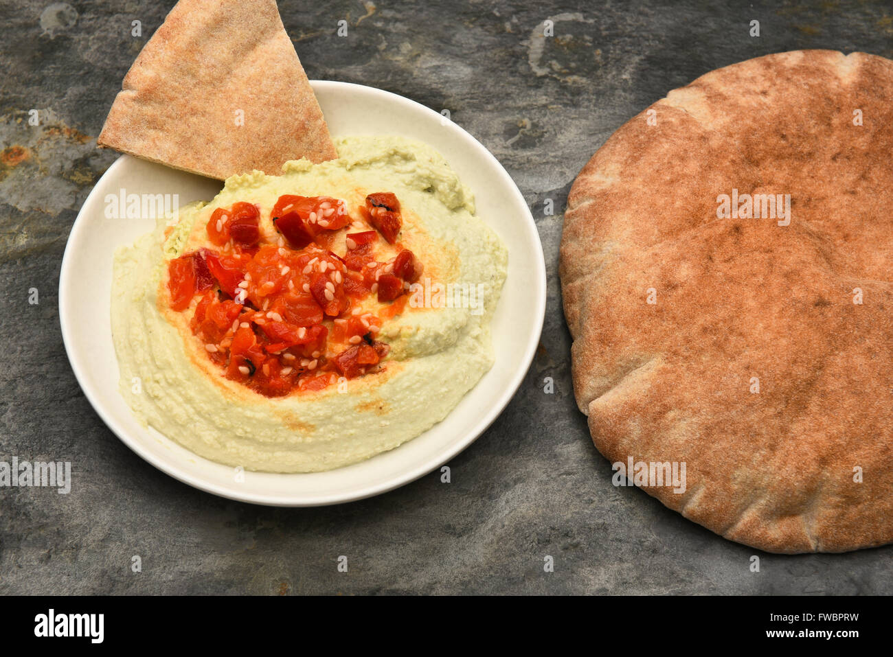 Top view of a bowl of edamame Hummus and pita bread. Horizontal format