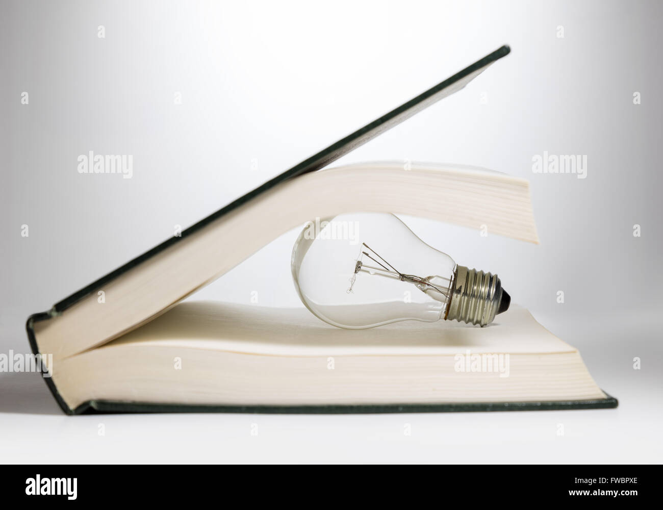 book and light bulb, business education concept Stock Photo - Alamy