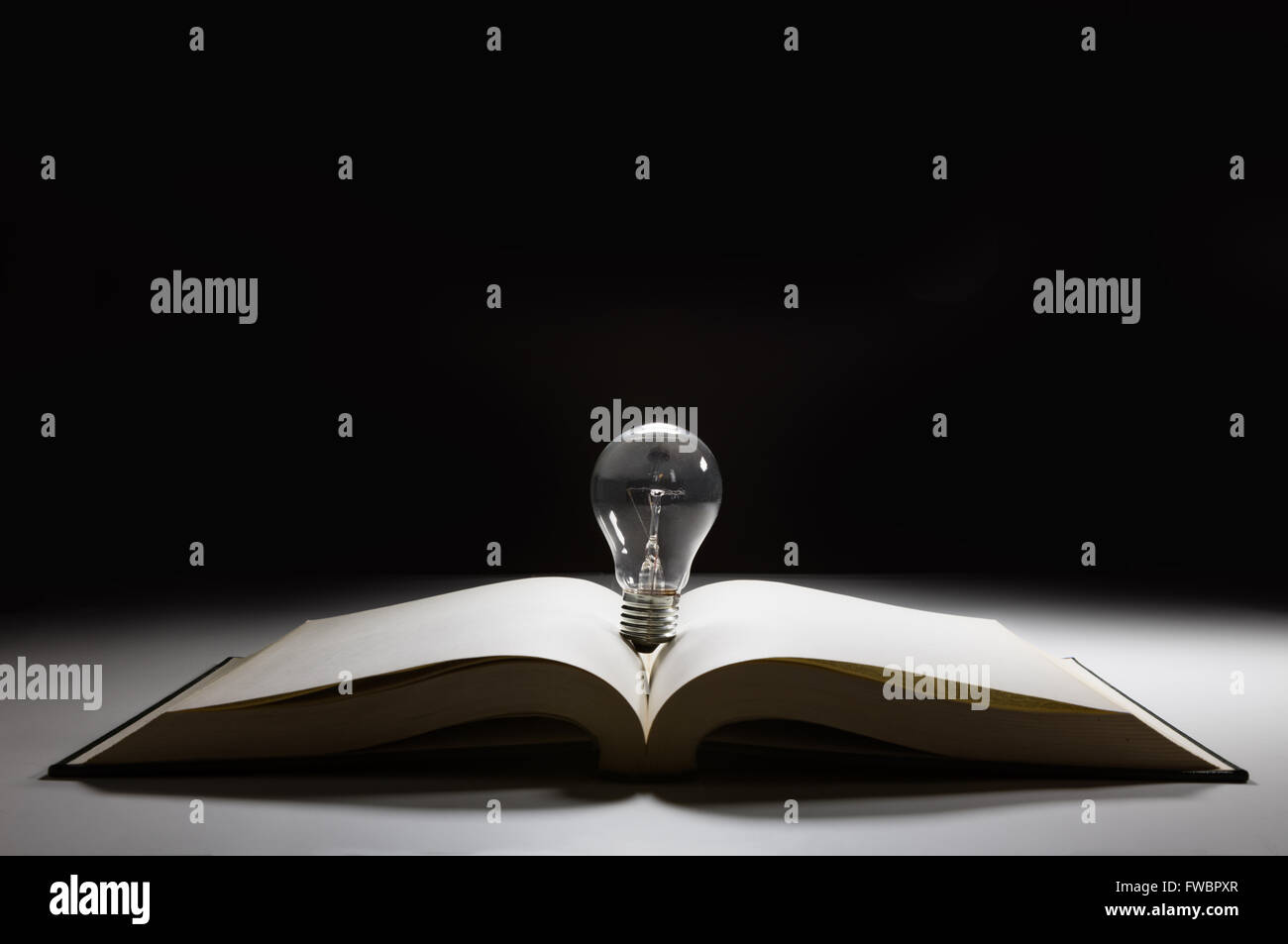 book and light bulb, business education concept Stock Photo - Alamy