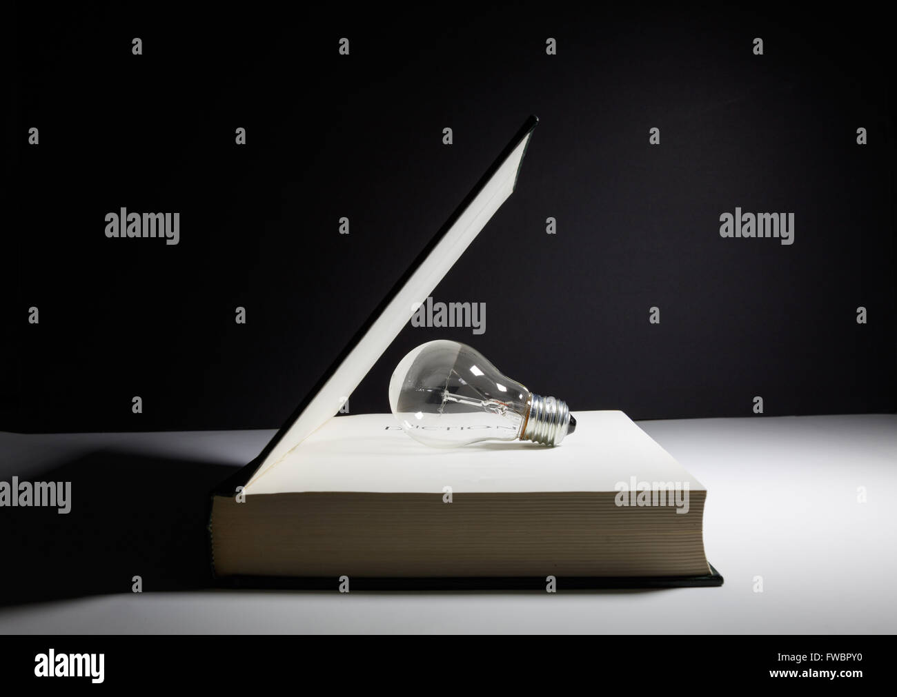 book and light bulb, business education concept Stock Photo Alamy