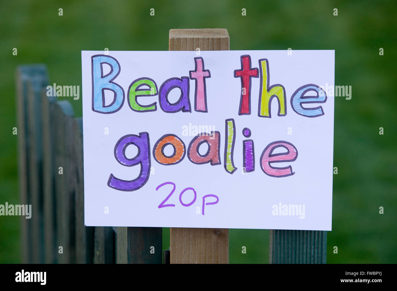 forretning Brug af en computer uklar A sign on a fence at a local village fete advertising a "beat the Goalie"  competition where participants shoot a number of footballs at the goal  keeper and if they achieve a