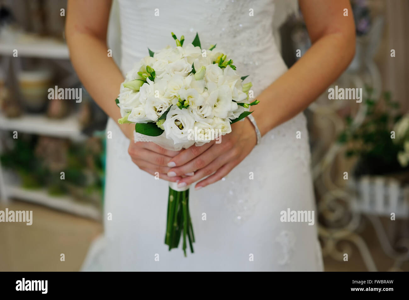 Bride holding white wedding bouquet of roses Stock Photo - Alamy
