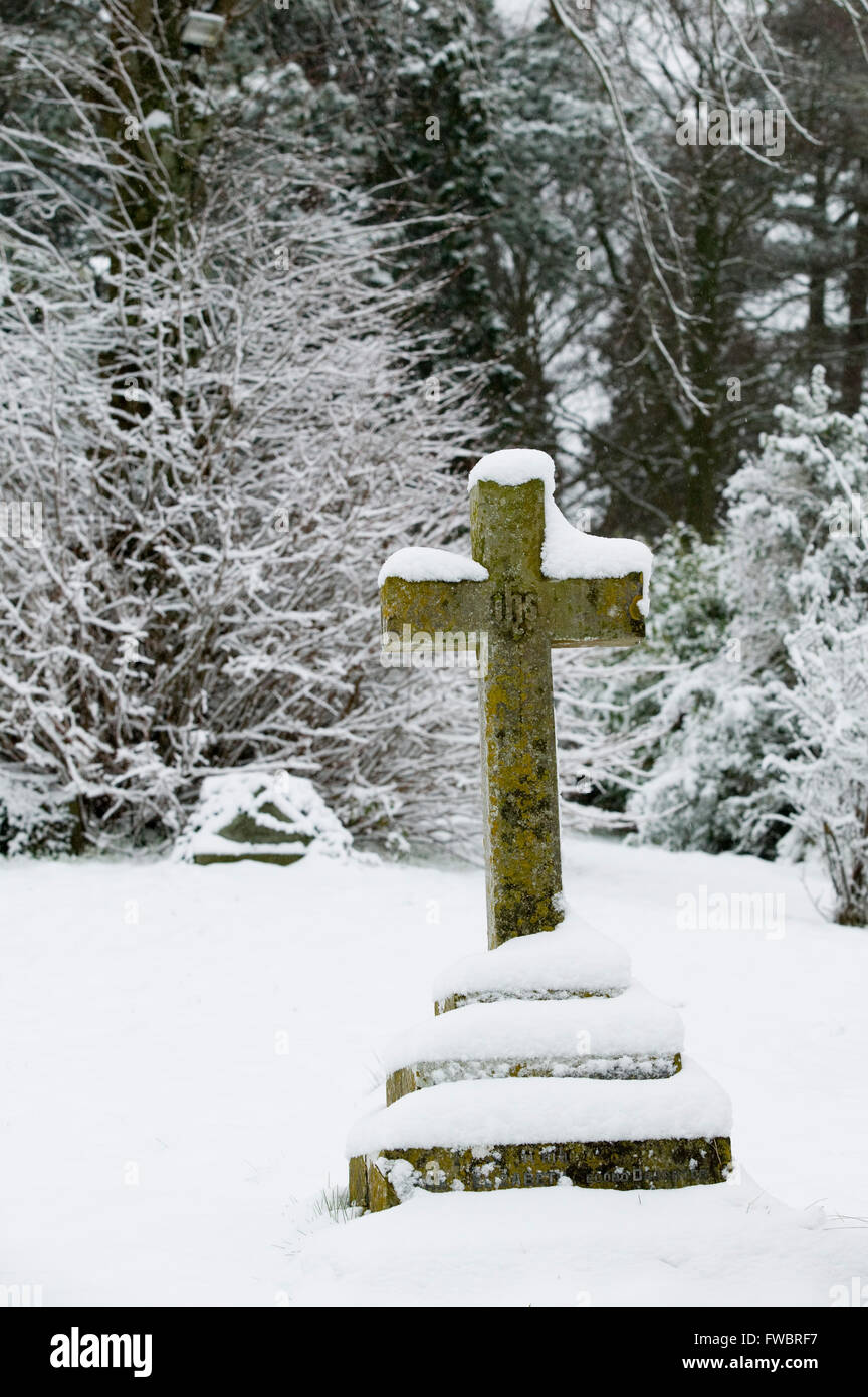 A Stone Cross Marks The Place Of A Burial In A Snow Covered Stock Photo Alamy