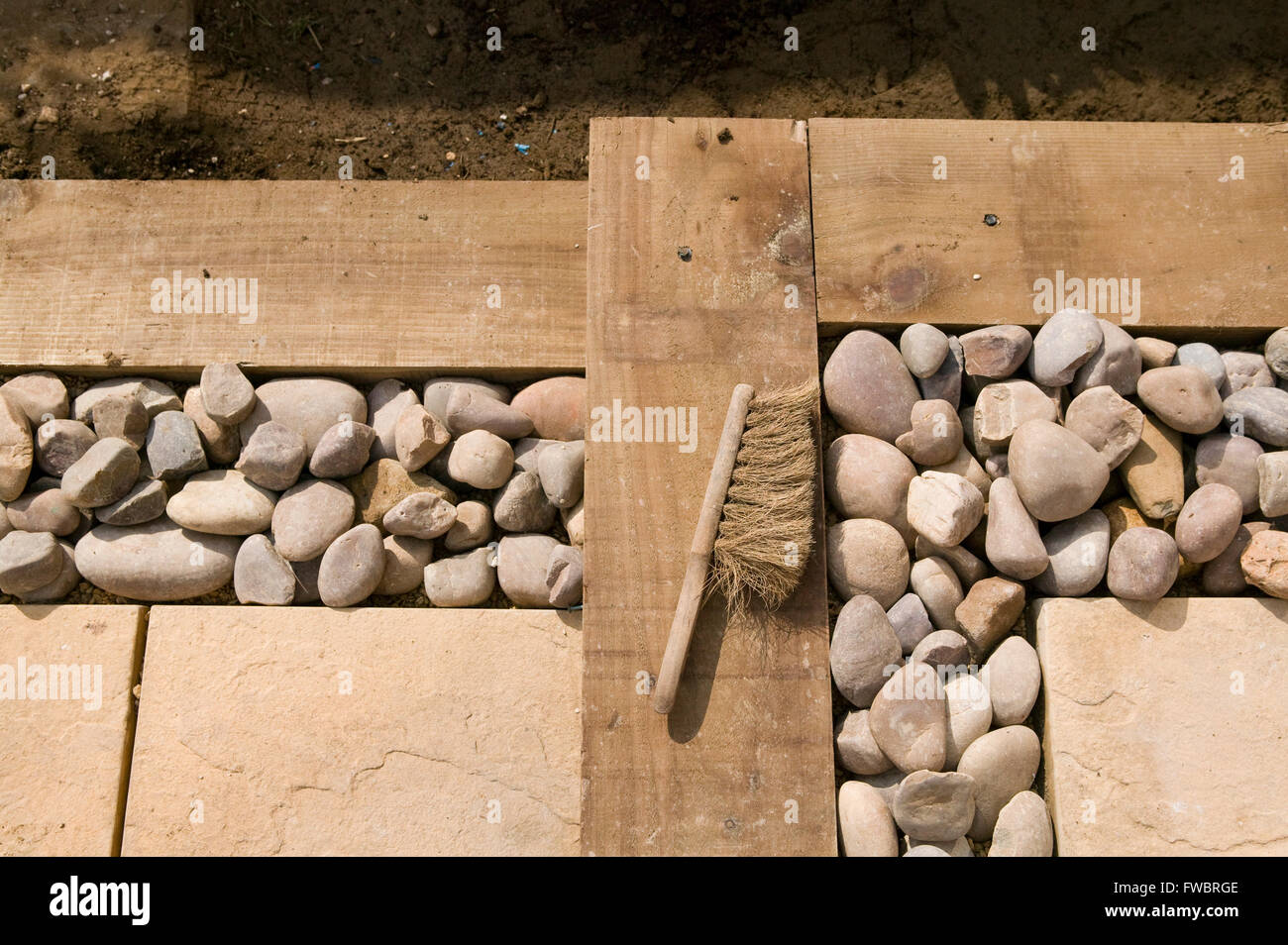 Preparing hard standing and decking areas in a small garden Stock Photo