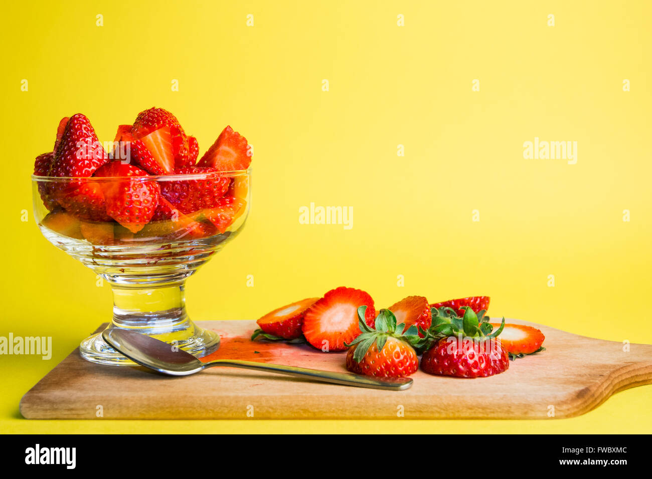 a glass of strawberries freshly prepared and ready to eat photographed ...