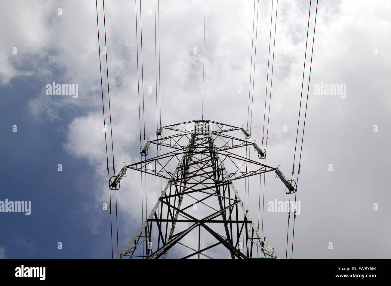Electric pylon set against a blue sky with clouds Stock Photo - Alamy