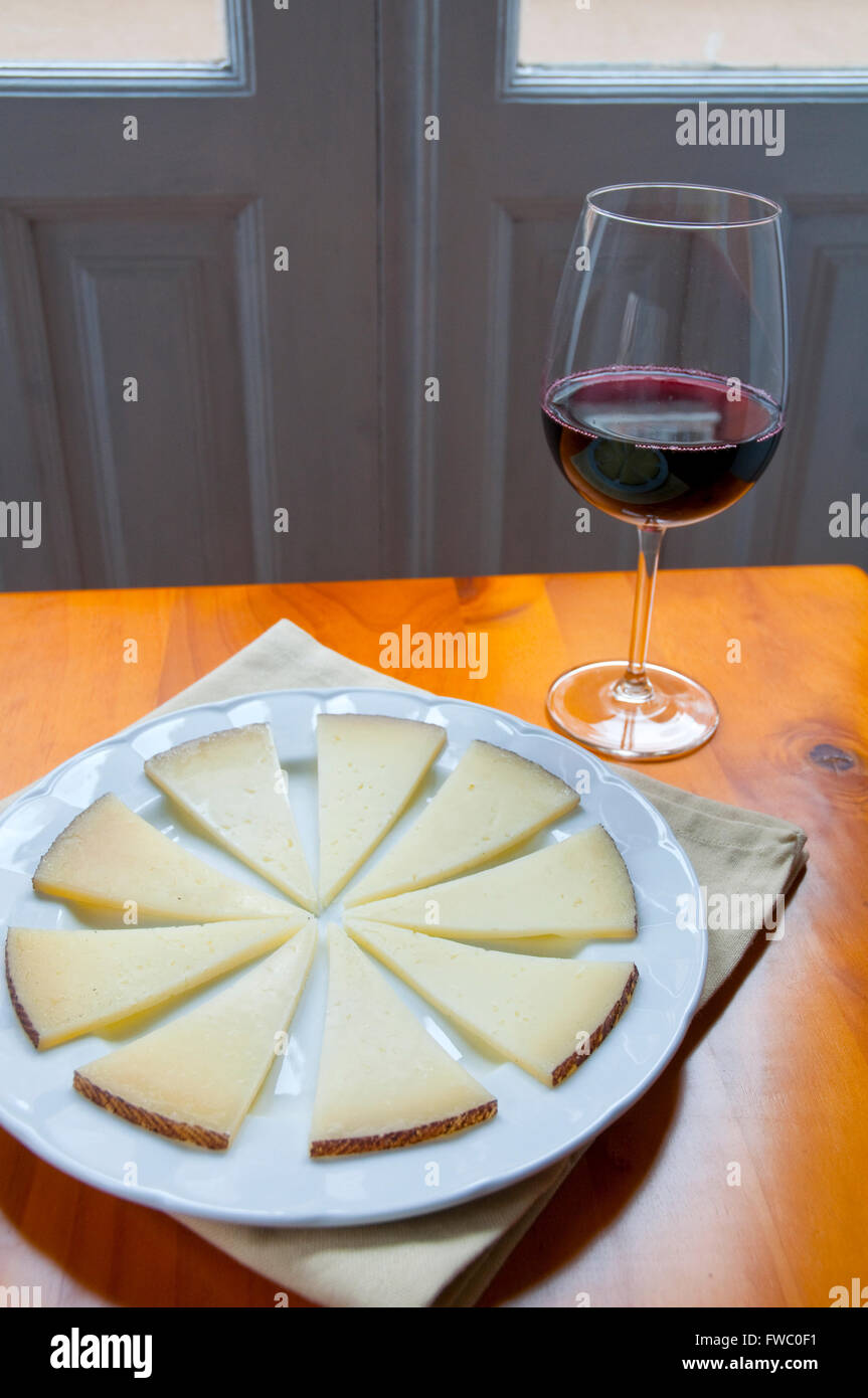 Manchego cheese serving and glass of red wine. Spain Stock Photo Alamy