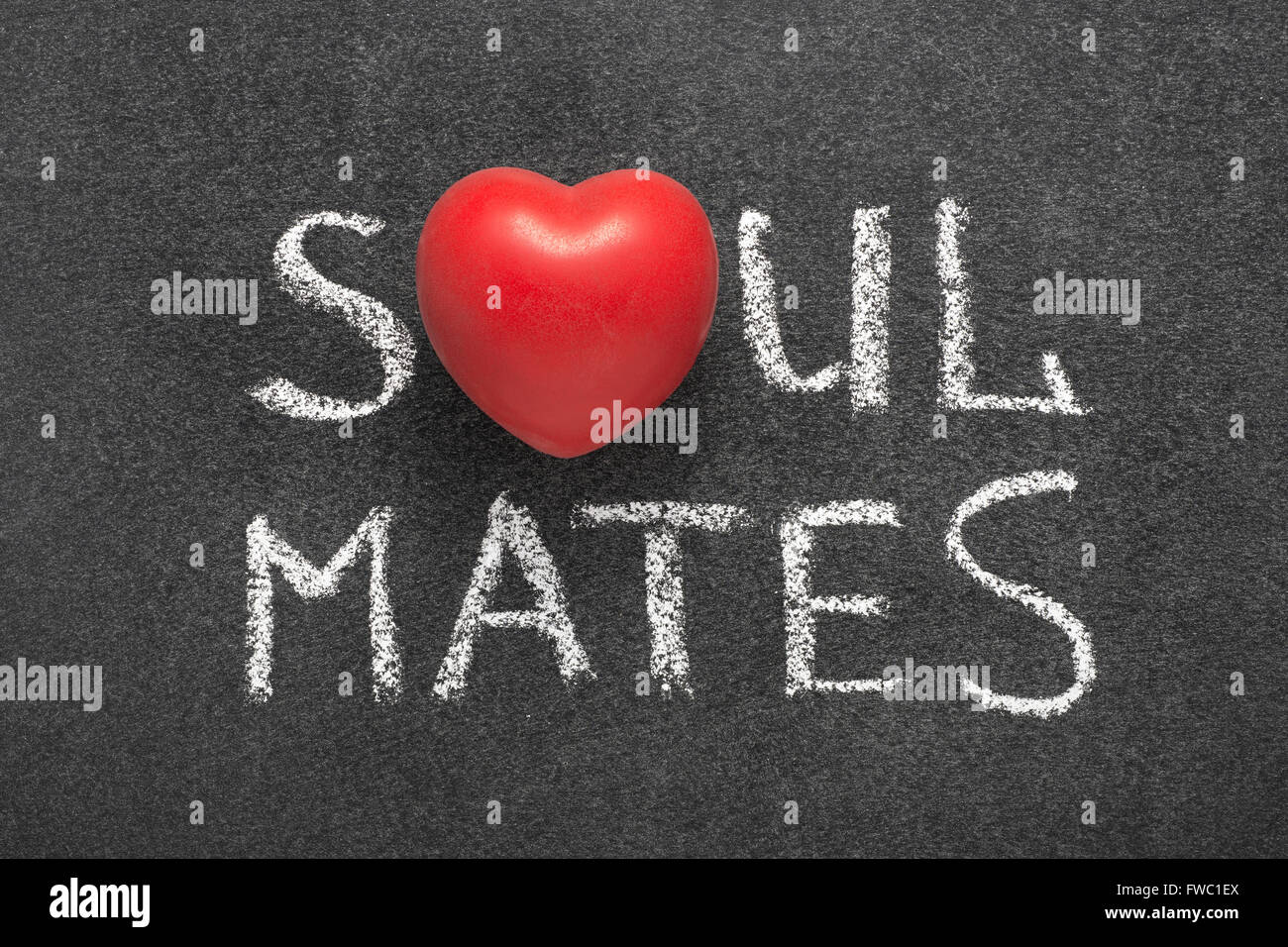 soul mates phrase handwritten on blackboard with heart symbol instead of O Stock Photo