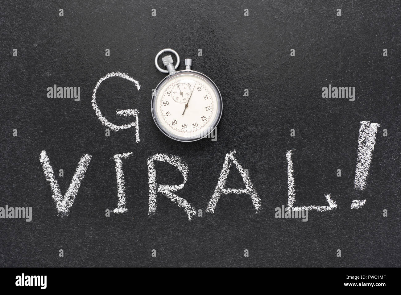 go viral exclamation handwritten on chalkboard with vintage precise stopwatch used instead of O Stock Photo