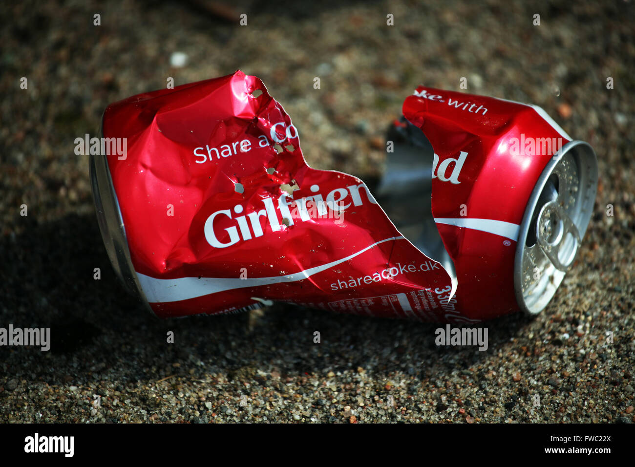 Broken coke can illustrates the end of a summer love story Stock Photo
