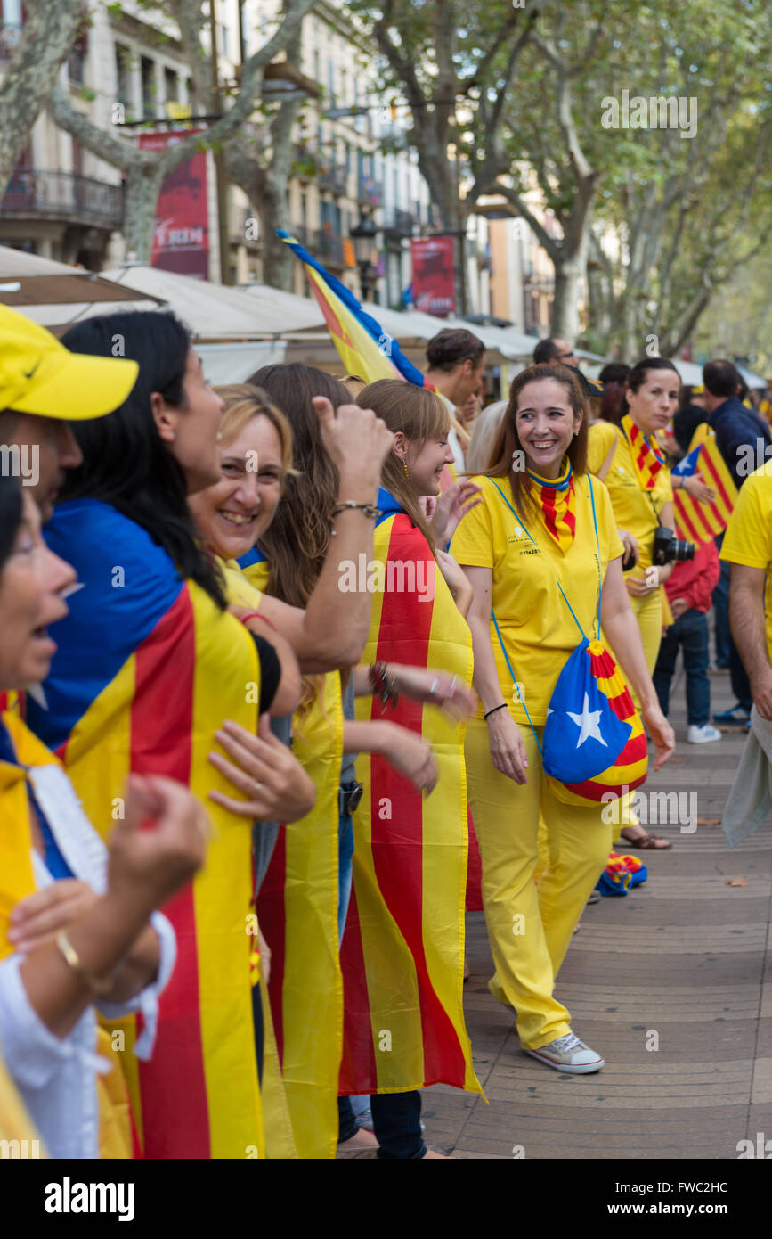 Line of people with Catalan flags on Barcelona at National Day of Catalonia, Spain Stock Photo