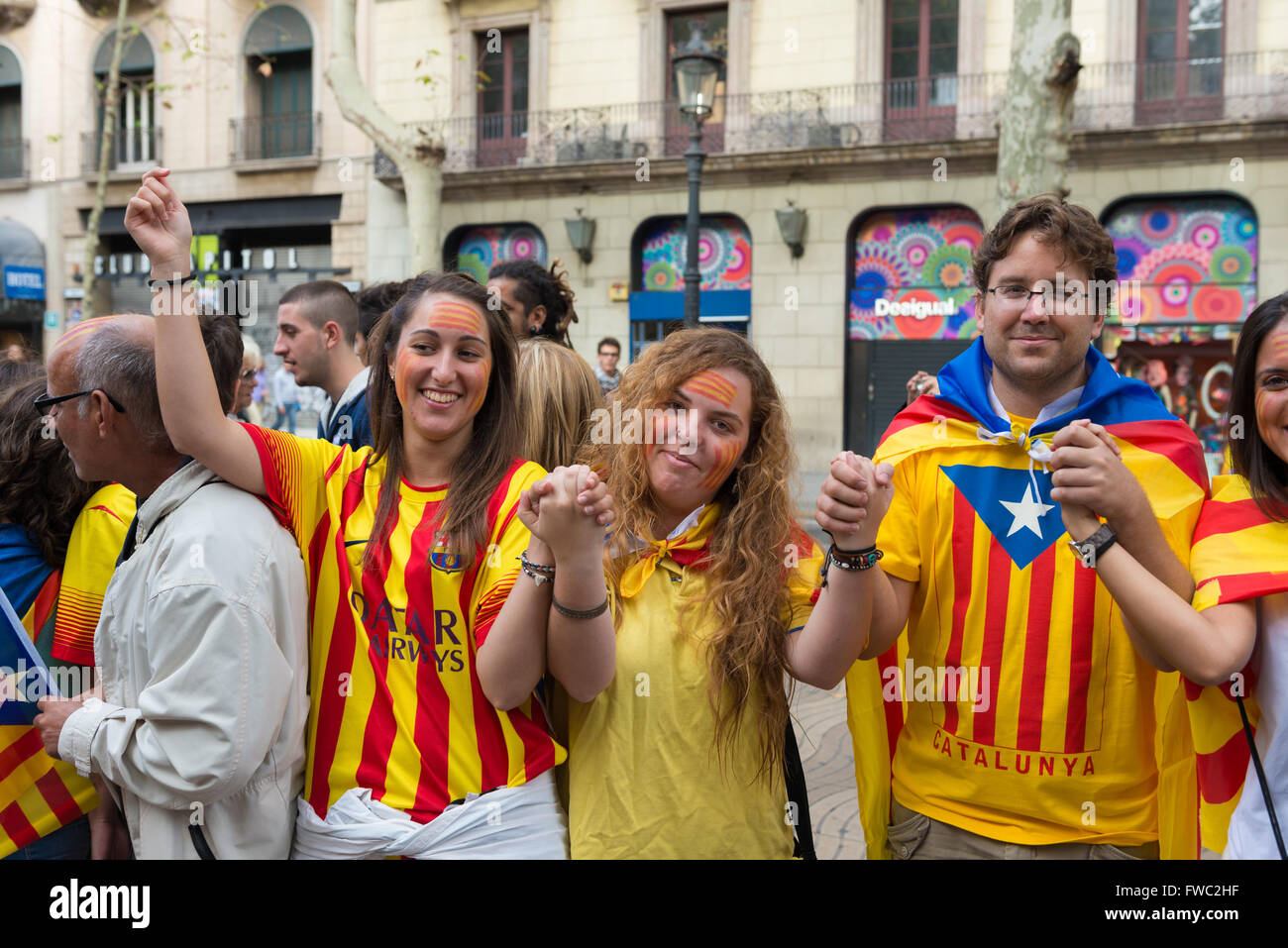 Catalan young people with the pattern of the independence flag on the National Day of Catalonia, Barcelona, Spain Stock Photo