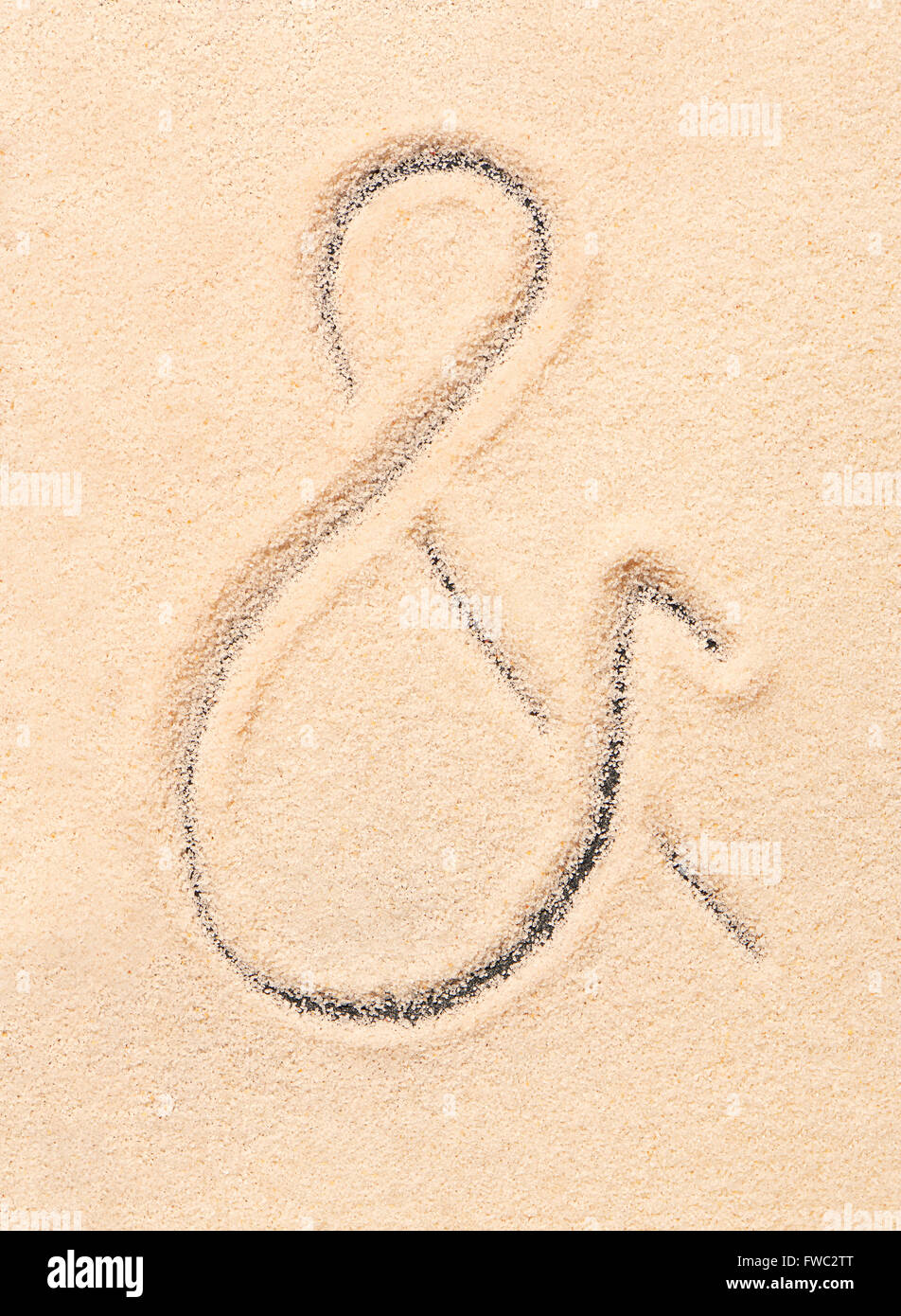 Ampersand symbol drawn on sand. Summer beach background Stock Photo