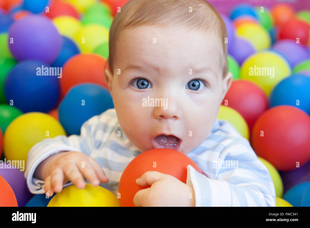 8 month baby boy playing in the playground balls pool Stock Photo Alamy