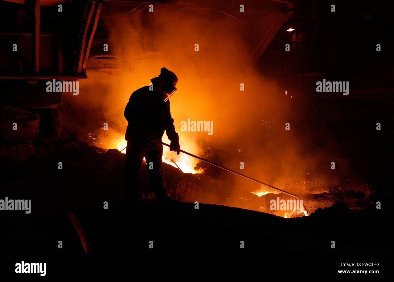 Team member taking iron samples using a lance on Blast Furnace No 5 at Port Talbot Steelworks South Wales UK Stock Photo