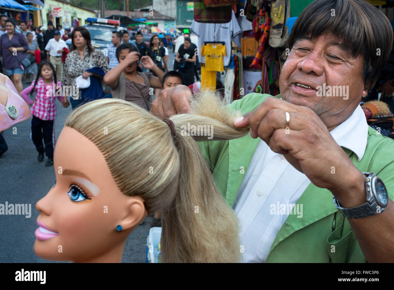 Wig seller in the Antigua streets, Guatemala. Stock Photo