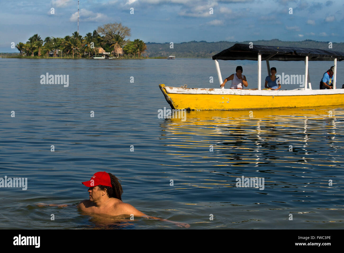 FLORES, GUATEMALA - Bathing in front of the small island in Lago Peten Itza, near the colonial village of Flores. Stock Photo