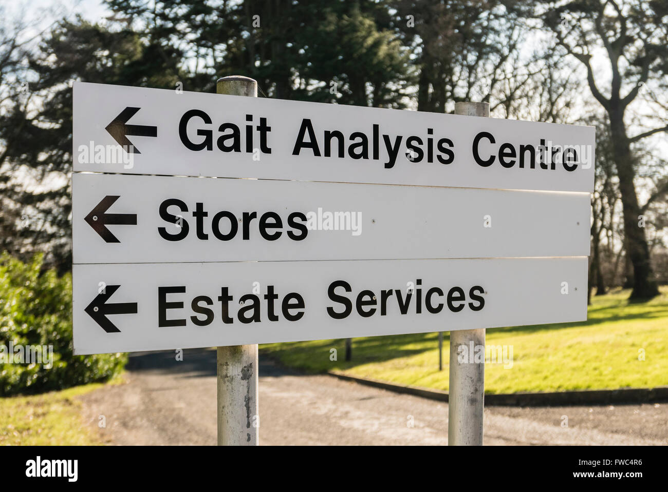 Sign at a hospital giving directions to the Gait Analysis Centre, Stores and Estate Services Stock Photo