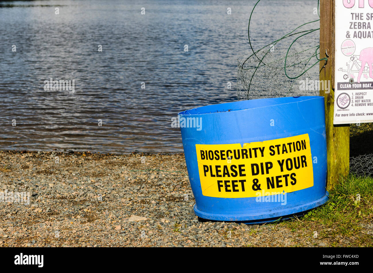 Bucket of disinfectant at a lough for fishermen to clean their boots, feet, nets and other equipment to prevent spread of zebra mussels Stock Photo