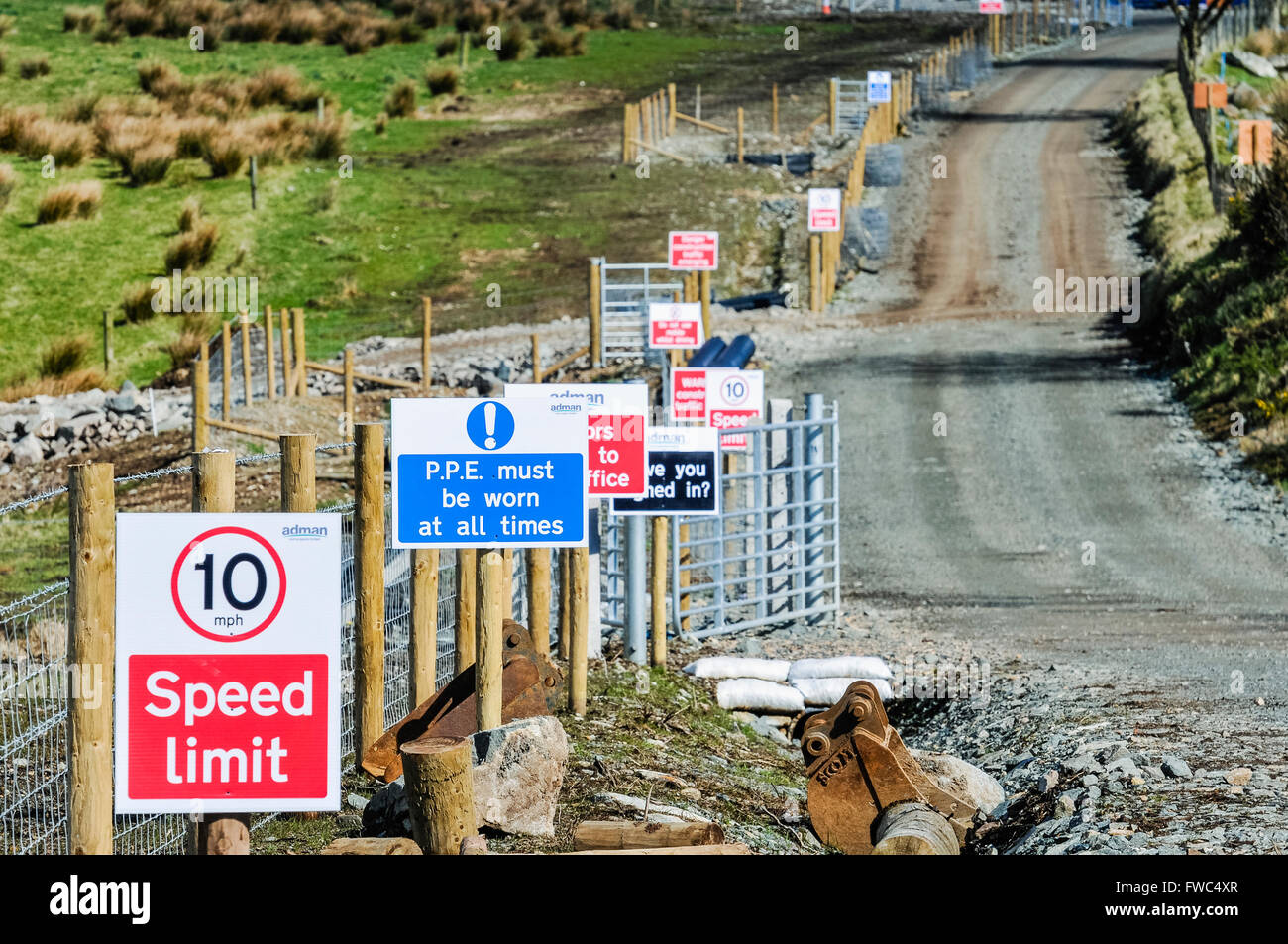 Signs along the path of a construction site including Speed Limit, PPE must be worn etc. Stock Photo