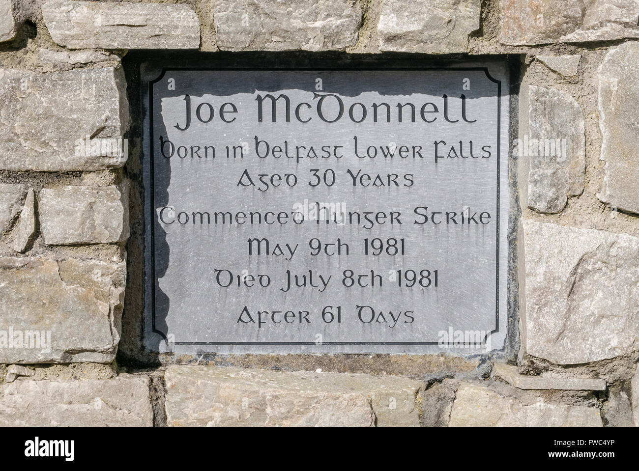Memorial plaque in a garden of remembrance for the 1981 Irish Republican hunger striker Joe McDonnell Stock Photo