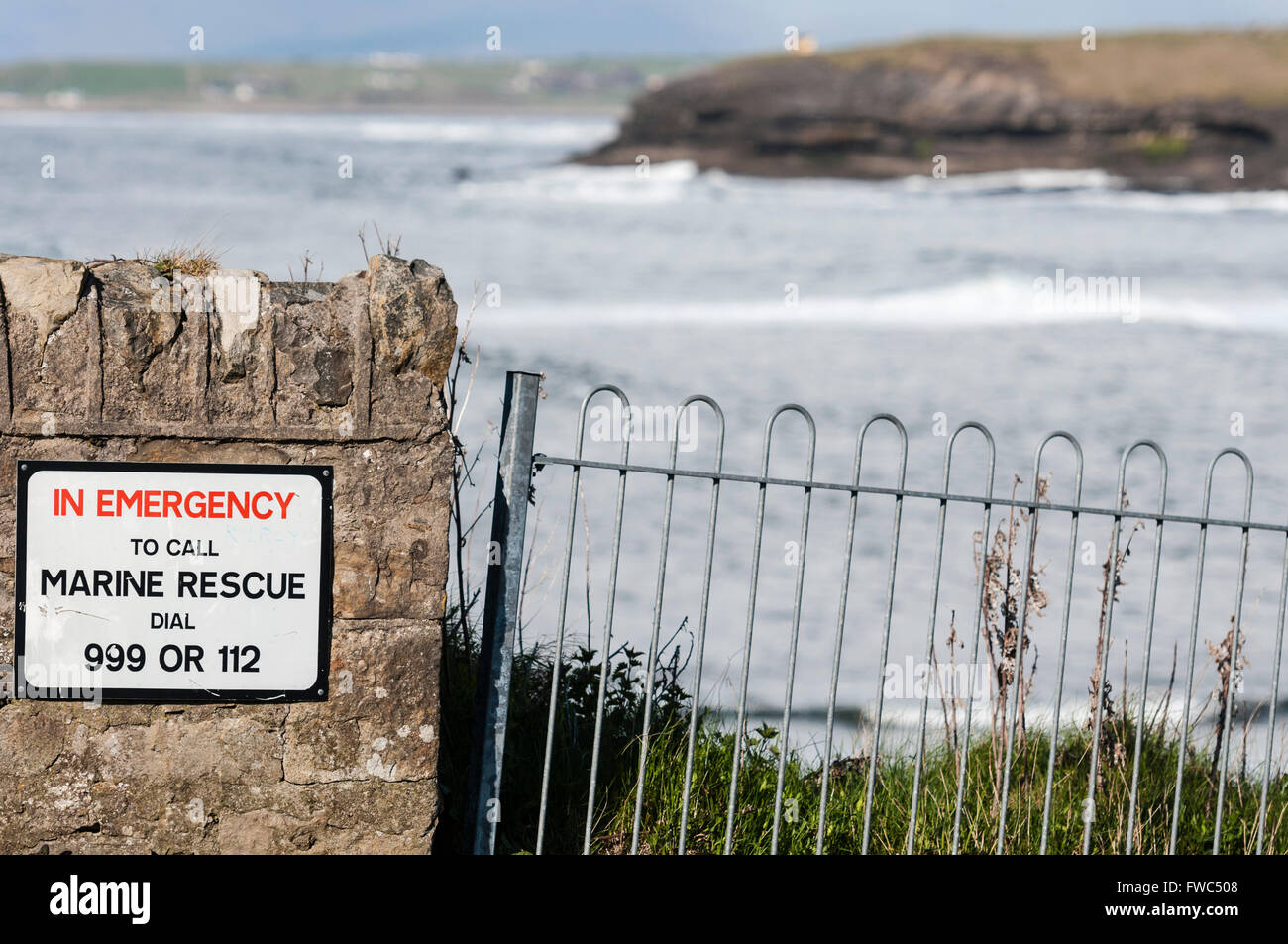 Sign at a sea front saying 'In emergency to call marine rescue dial 999 or 112' Stock Photo