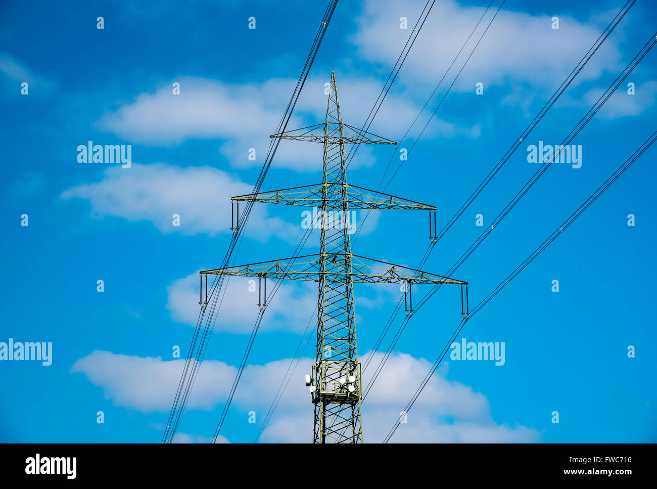 High voltage tower sky background Stock Photo - Alamy