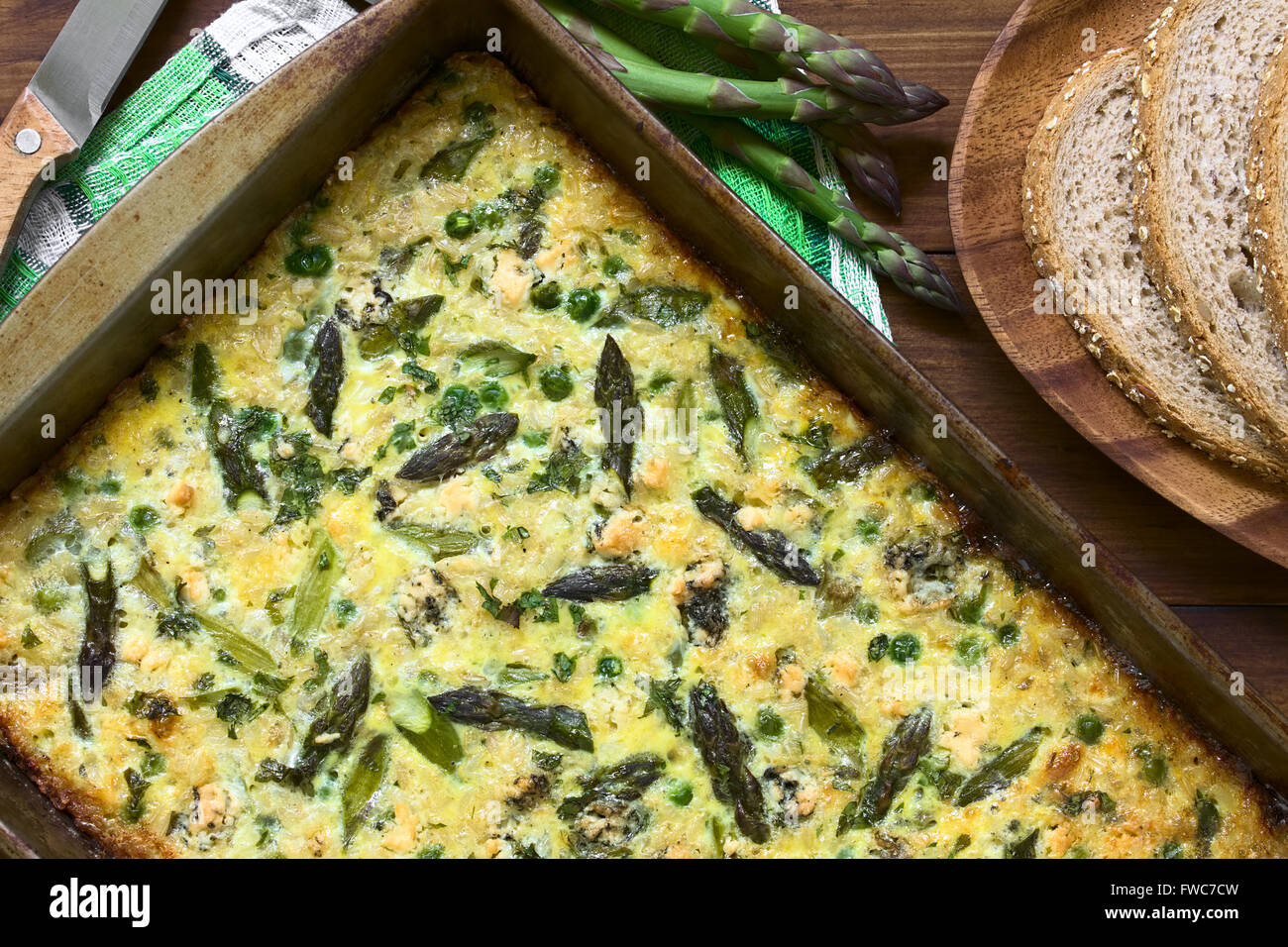 Frittata made of eggs, green asparagus, pea, blue cheese, parsley and