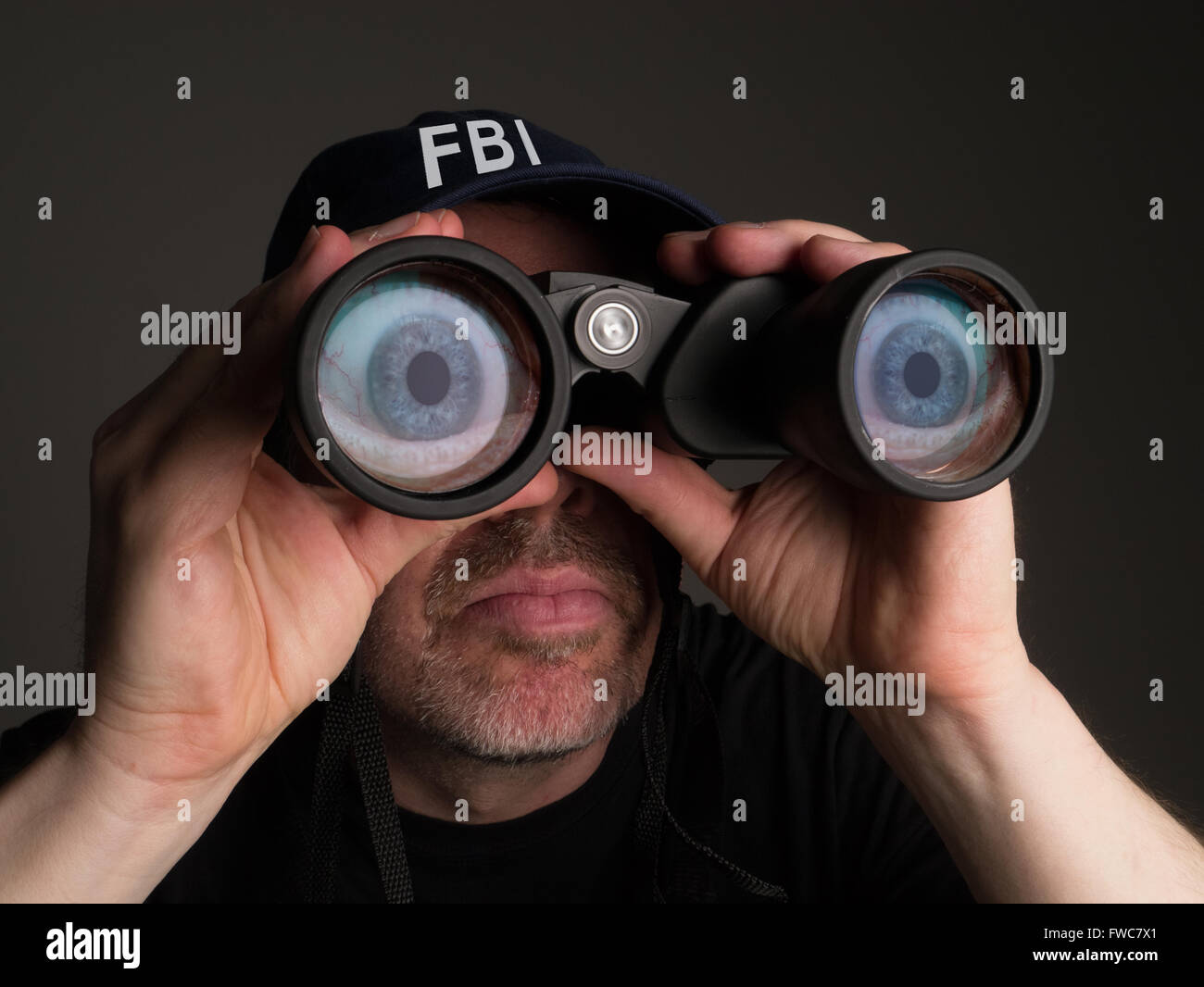 FBI agent with big cartoon eyes and binoculars Stock Photo