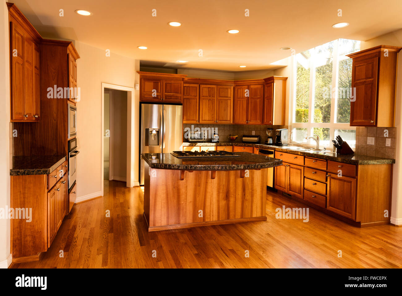 Open view of large home kitchen with all stainless steel appliances Stock Photo