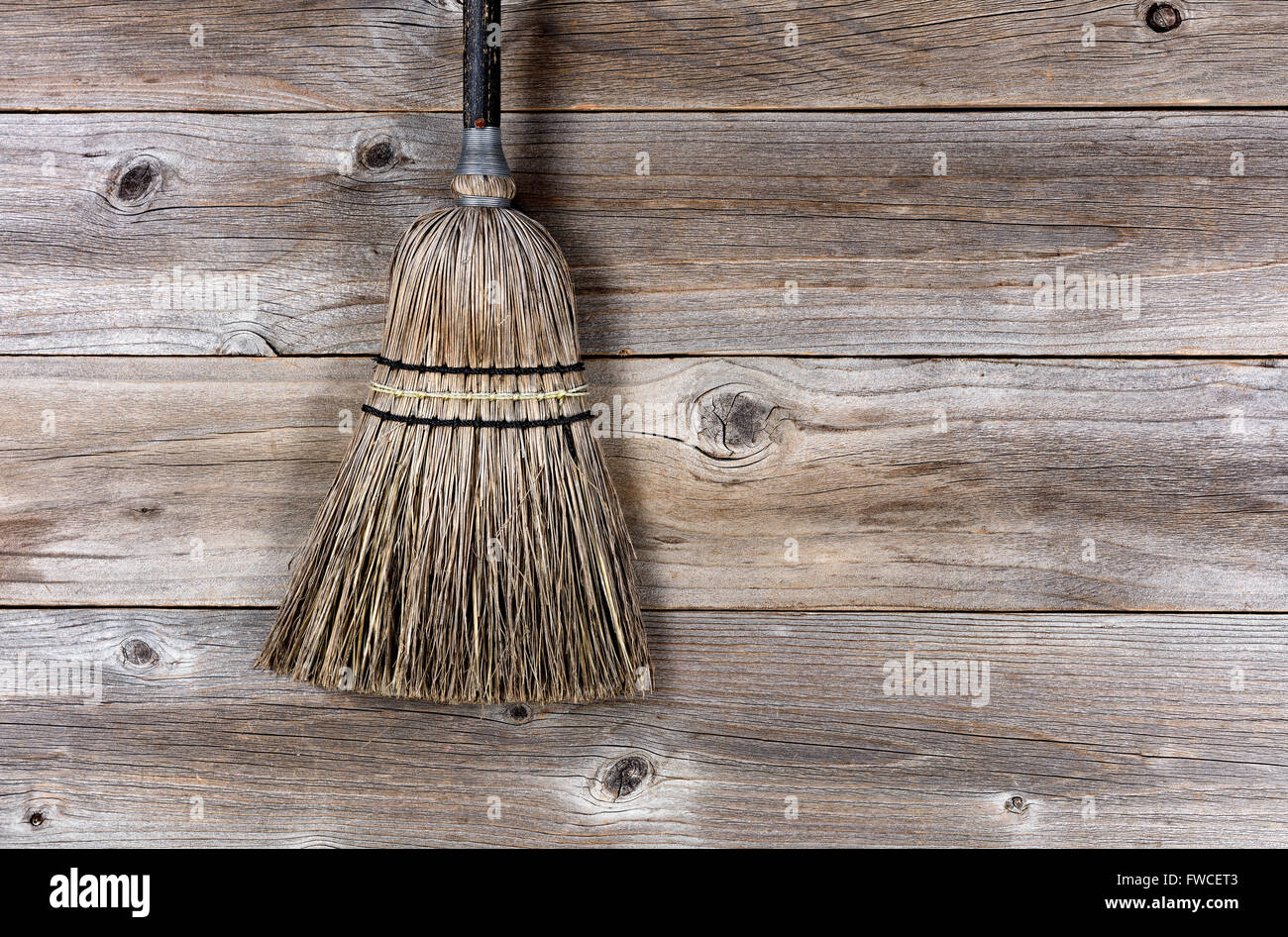 Old straw broom on stressed wooden floor Stock Photo Alamy