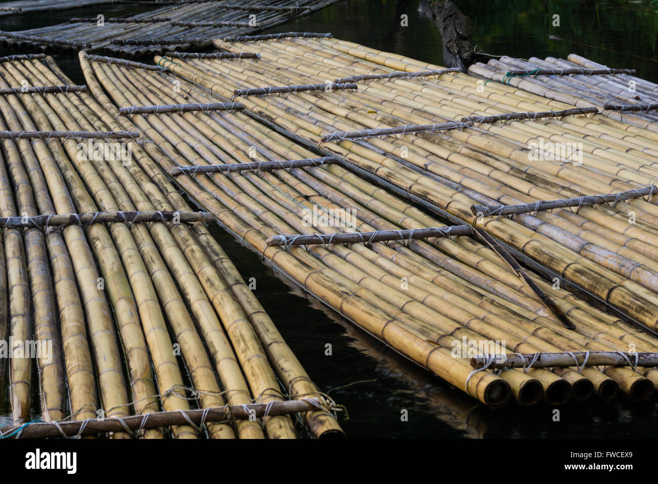 Traditional bamboo rafts were how locals traveled and carried goods for trade. Stock Photo