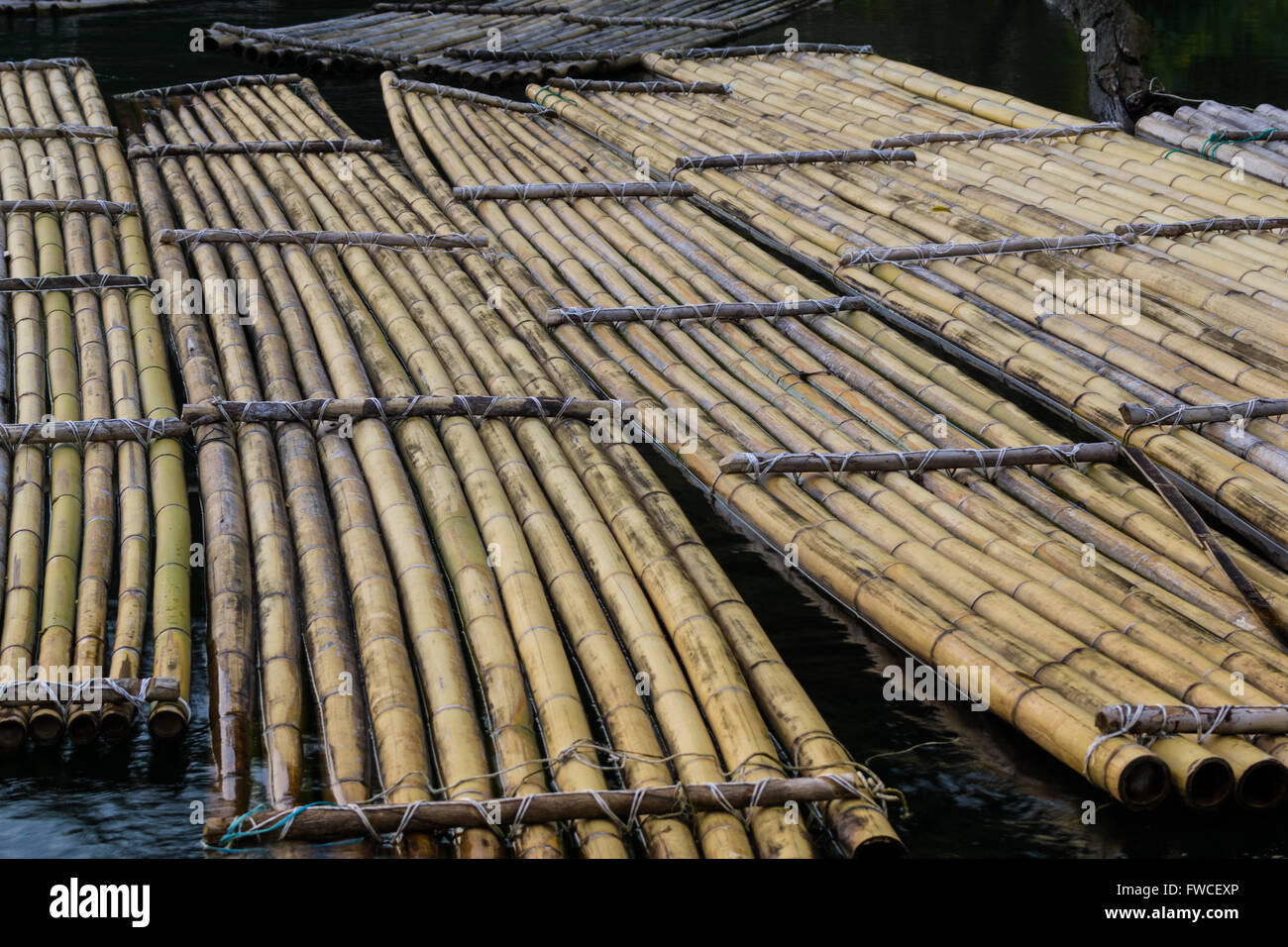 Traditional bamboo rafts were how locals traveled and carried goods for trade. Stock Photo