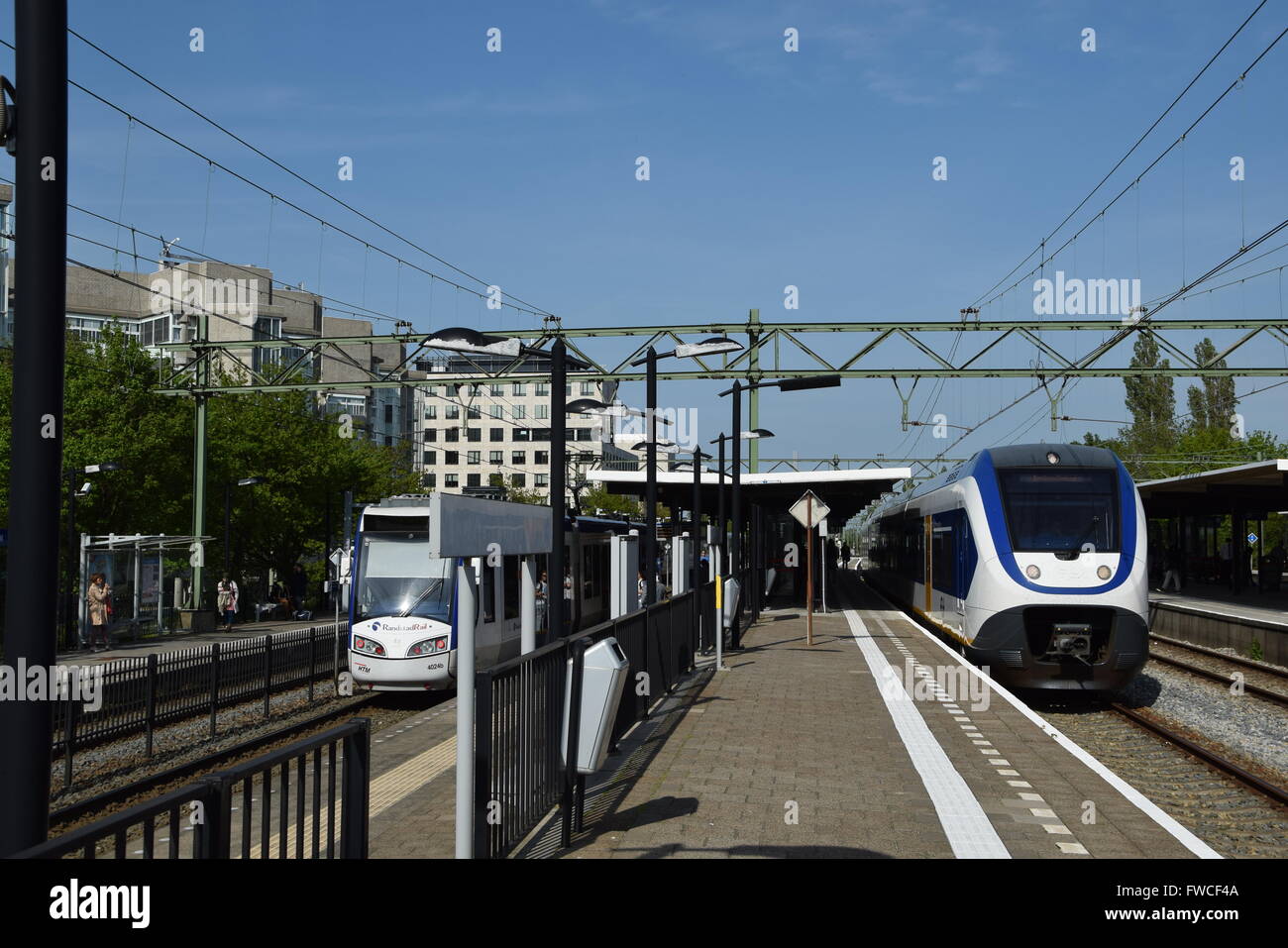 NS train and Randstadrail tram at the Laan van NOI station platforms interchange Stock Photo