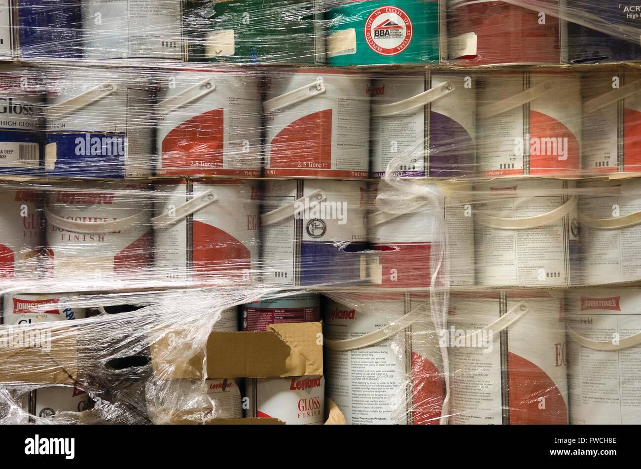 Much Hoole, Preston, Lancashire. Tins of donated Leyland paint sit in a charity warehouse waiting to be donated to needy causes. Stock Photo