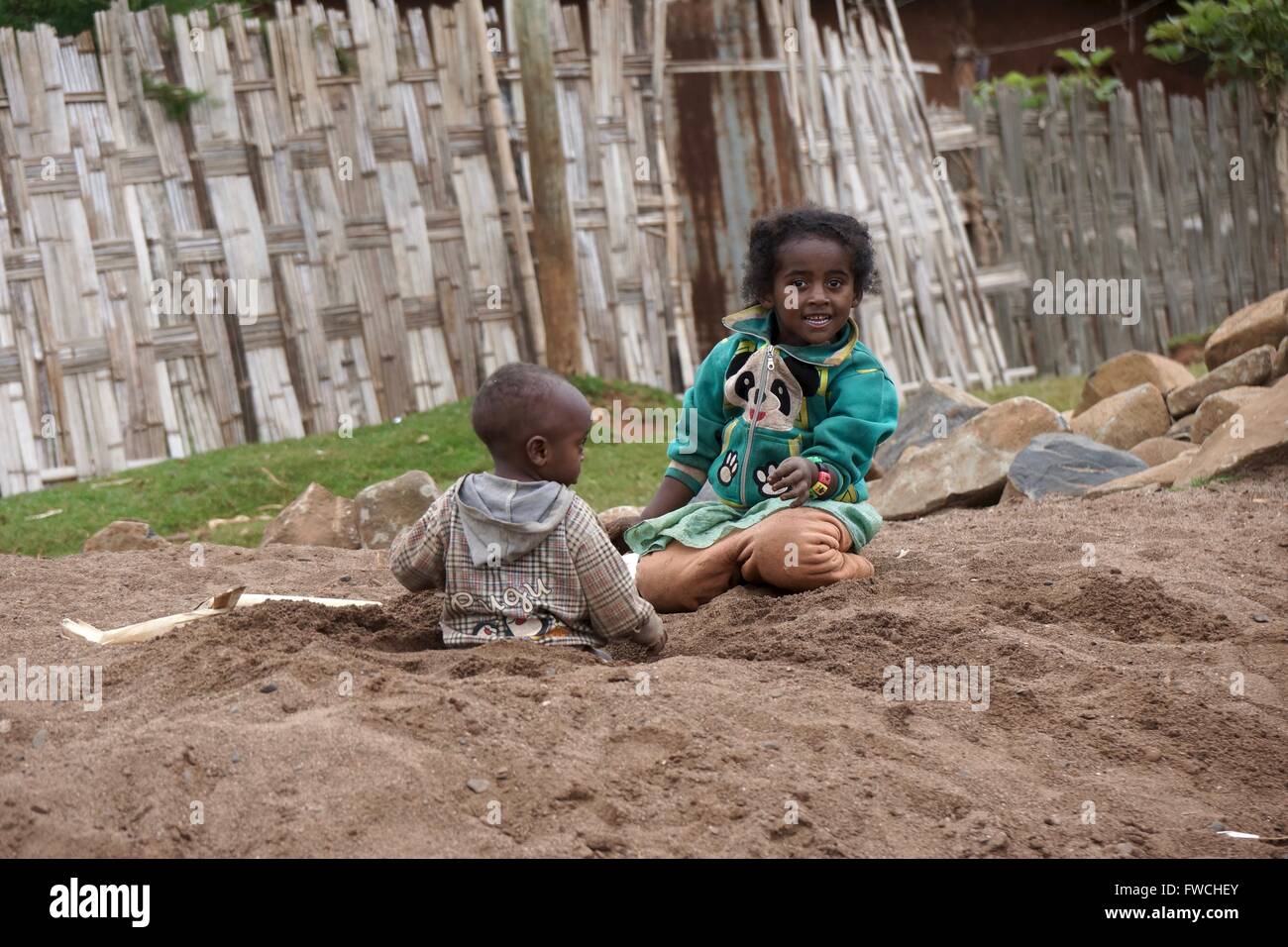 Two Ethiopian children playing in a makeshift sandpit. Stock Photo