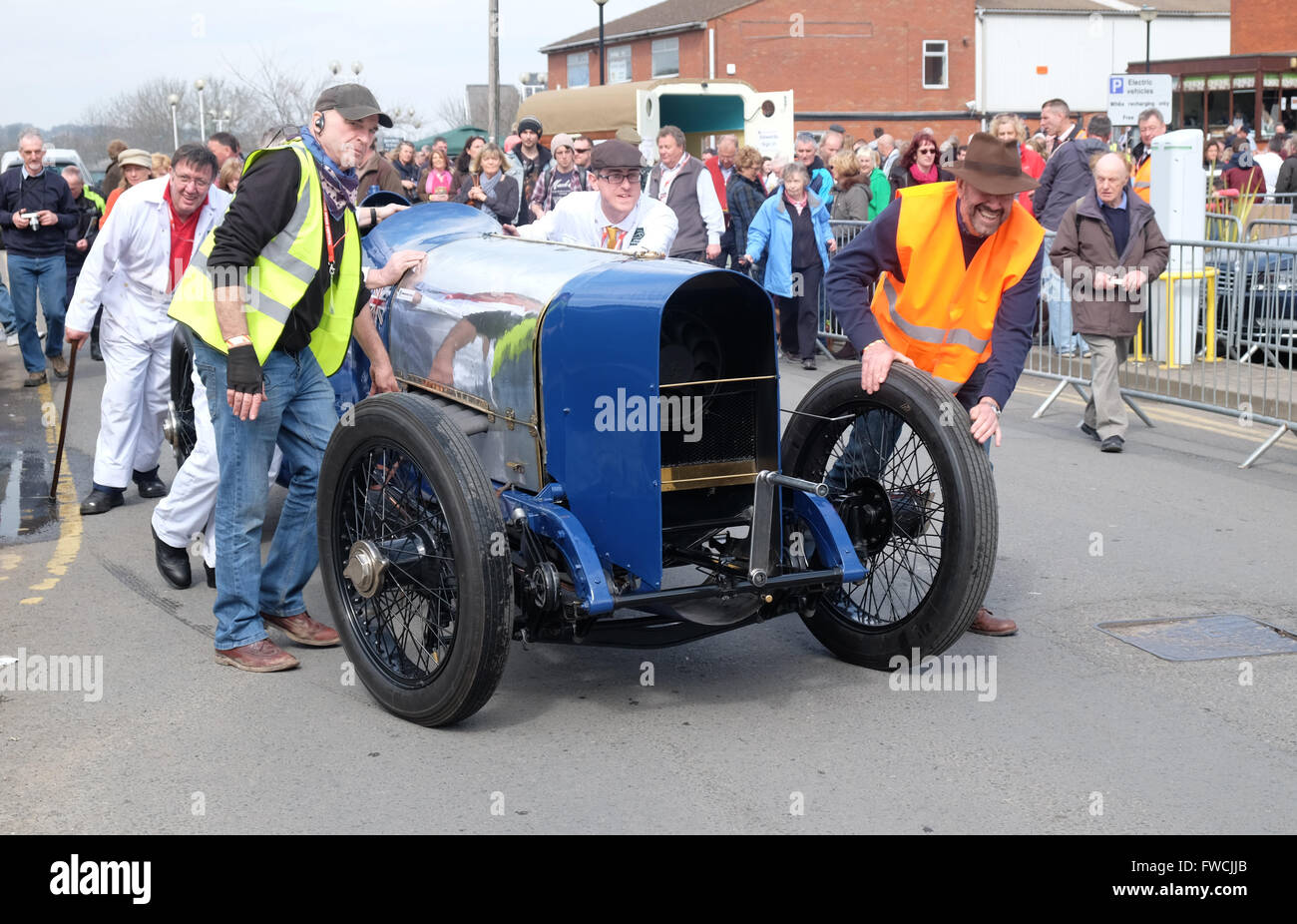 Bromyard, Herefordshire UK April, 2016 - the inaugural Speed Festival engineers and marshals push the legendary Bluebird once driven by Sir Malcom Campbell to the start line for a drive through the town - the car is a 1920 Sunbeam 350 HP. In 1925 Campbell broke the World Land Speed record in this vehicle for the third time with a speed of 150.75 mph. The Bluebird belongs to the National Motor Museum at Beaulieu. Stock Photo