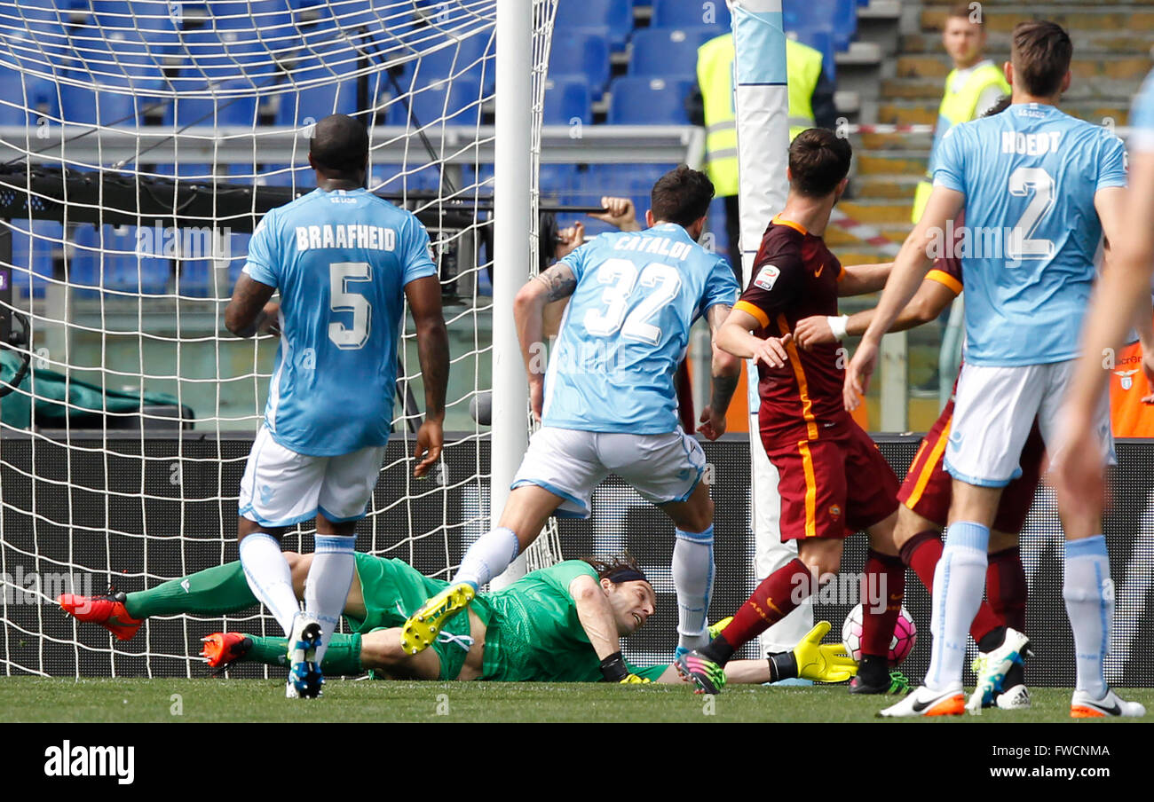 Rome, Italy. 03rd Apr, 2016. Lazio's goalkeeper Federico Marchetti, bottom, saves the ball during the Italian Serie A football match between Lazio and Roma at the Olympic stadium. Roma defeats Lazio's city rivals 4-1. Goals were scored by El Shaarawy, Dzeko, Florenzi and Perotti for Roma, Parolo for Lazio. © Riccardo De Luca/Pacific Press/Alamy Live News Stock Photo