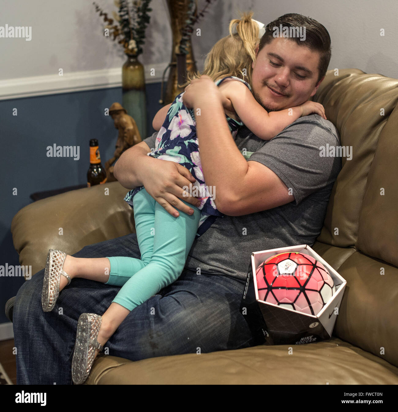La Habra, California, USA. 3rd Apr, 2016. During her family birthday party, DELANEY CHAMBERS, 4, of La Habra, California, hugs her uncle COLIN CHAMBERS, of Placentia, California, for the gift of a soccer ball. © Bruce Chambers/ZUMA Wire/Alamy Live News Stock Photo
