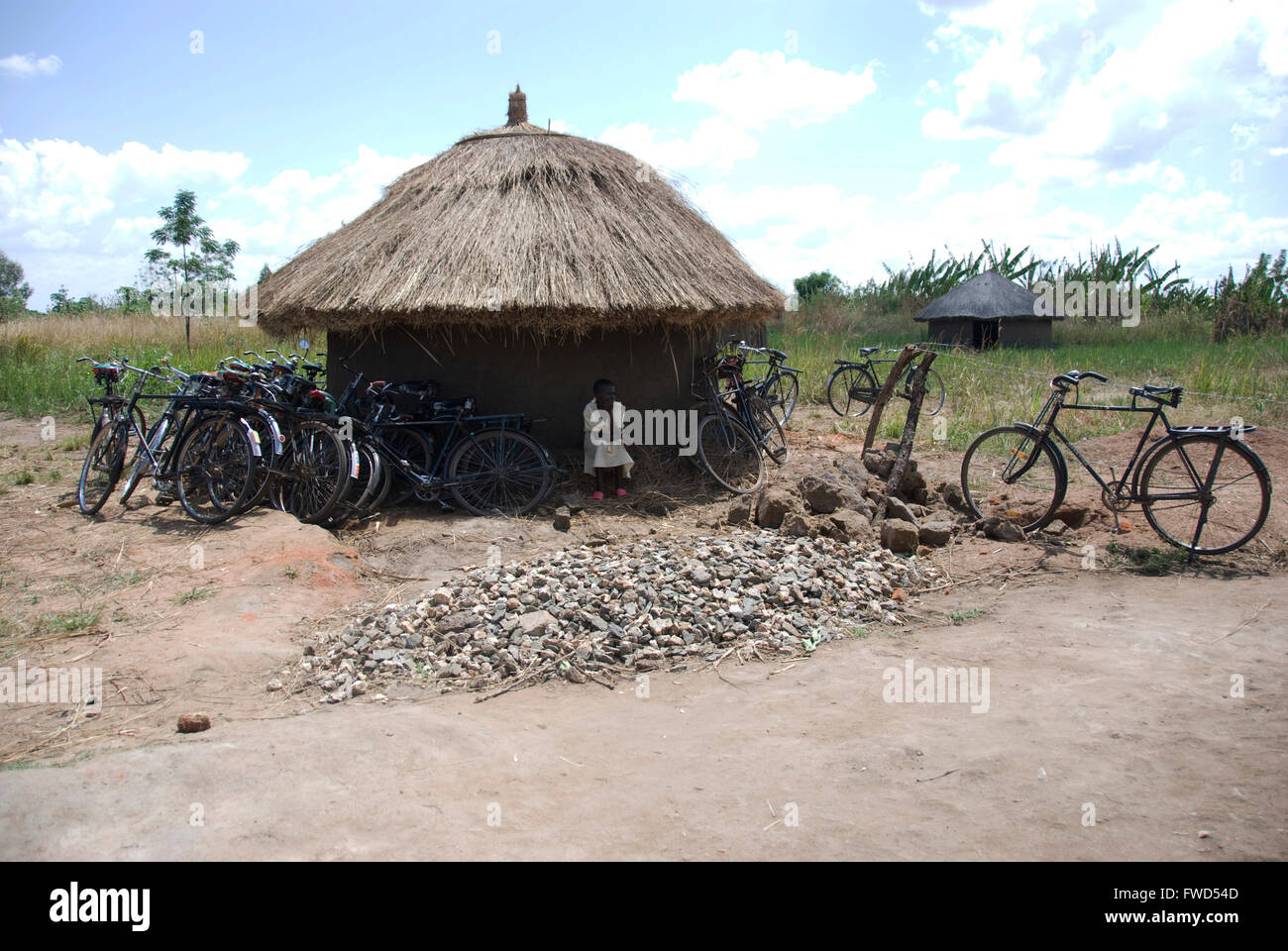 Lacekocot, Pader, Uganda. A mud hut and bicycles sit against a blue African sky Stock Photo