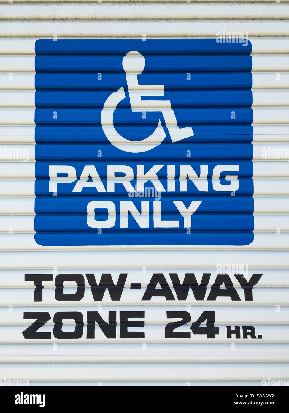 Disabled parking sign. Tow away zone 24 hours a day Stock Photo
