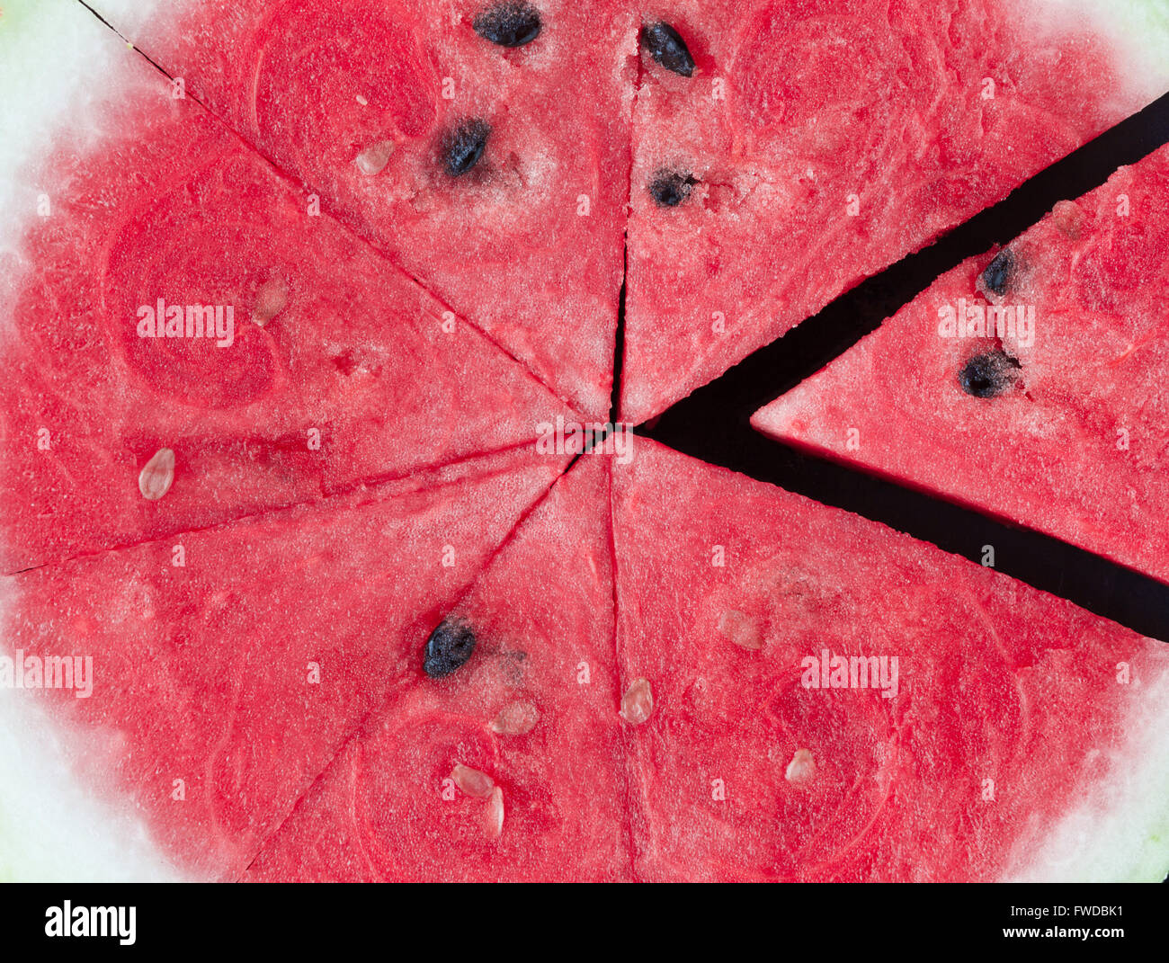 Triangle shaped watermelon slices on black bakcground extreme closeup Stock Photo