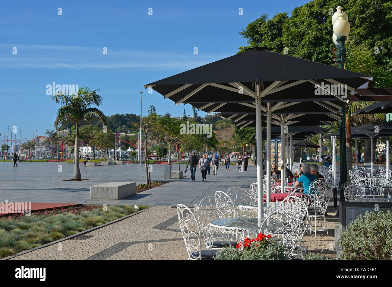 Cafe and people strolling on seafront promenade in Funchal, Madeira, Portugal Stock Photo