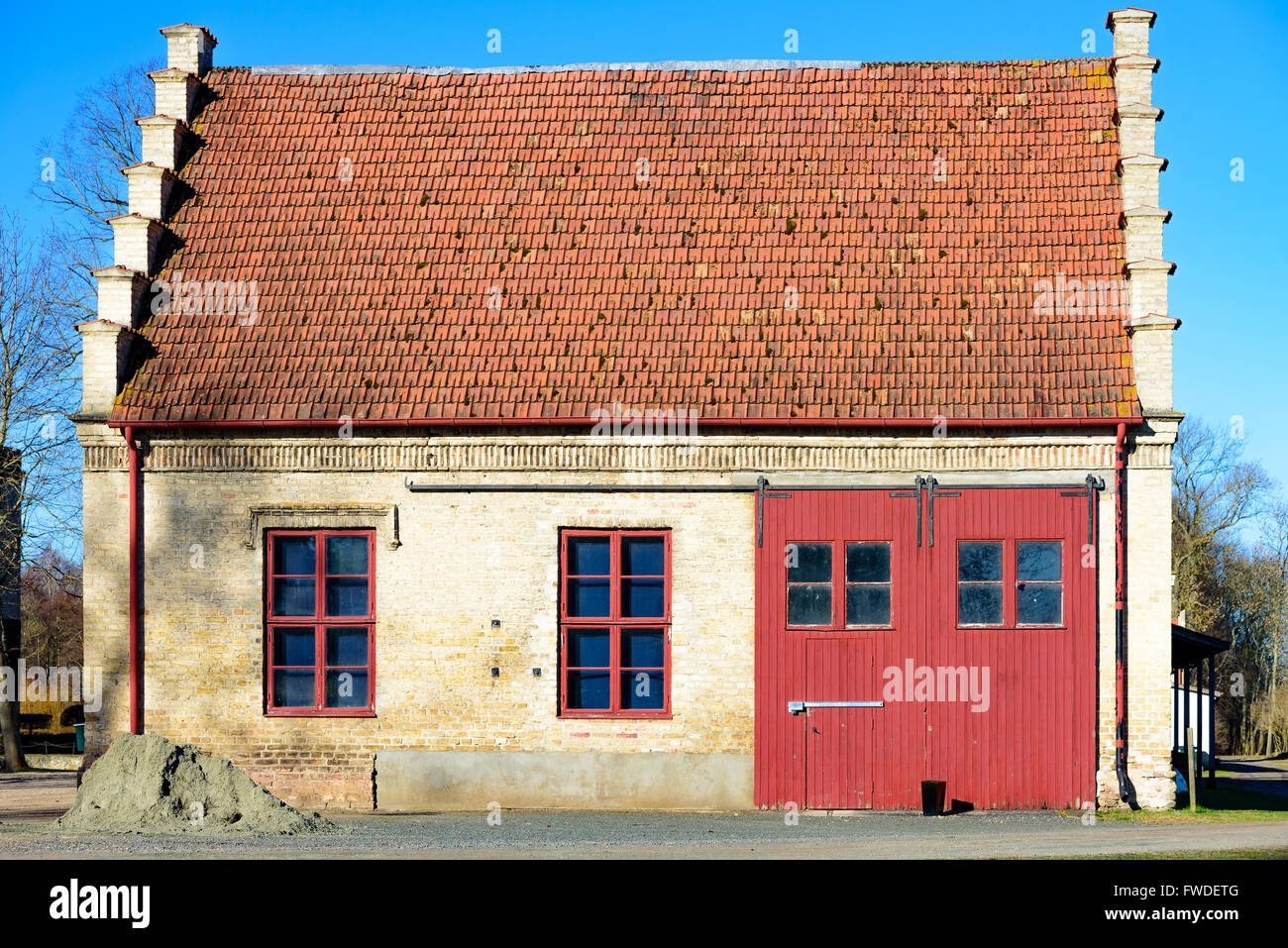 Vittskovle, Sweden - April 1, 2016: An old storage building with interesting architectural details. Large vehicle door and two w Stock Photo