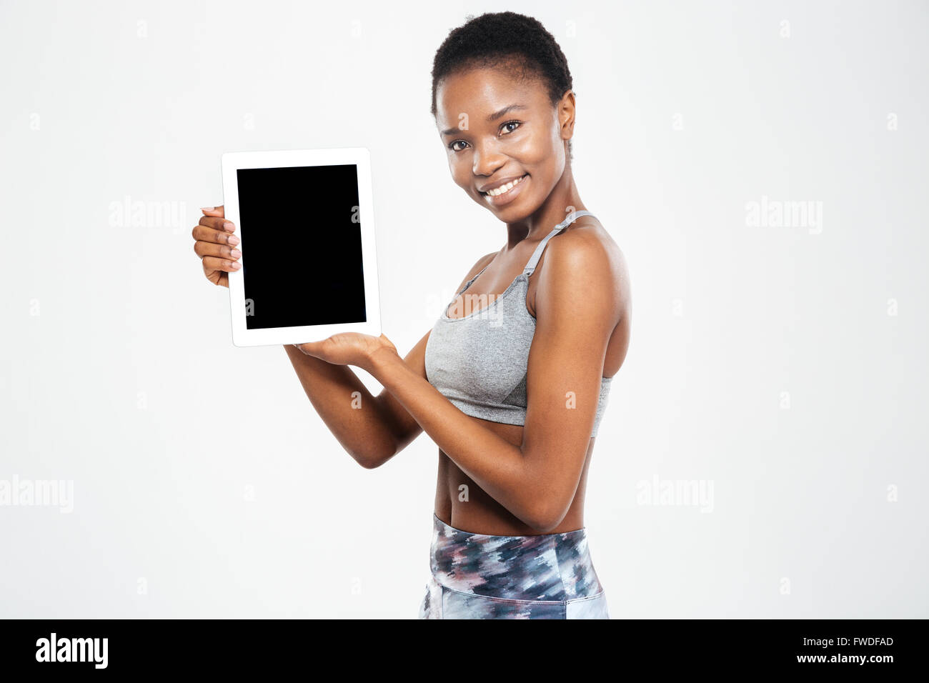 Happy afro american woman showing blank tablet computer screen isolated ...