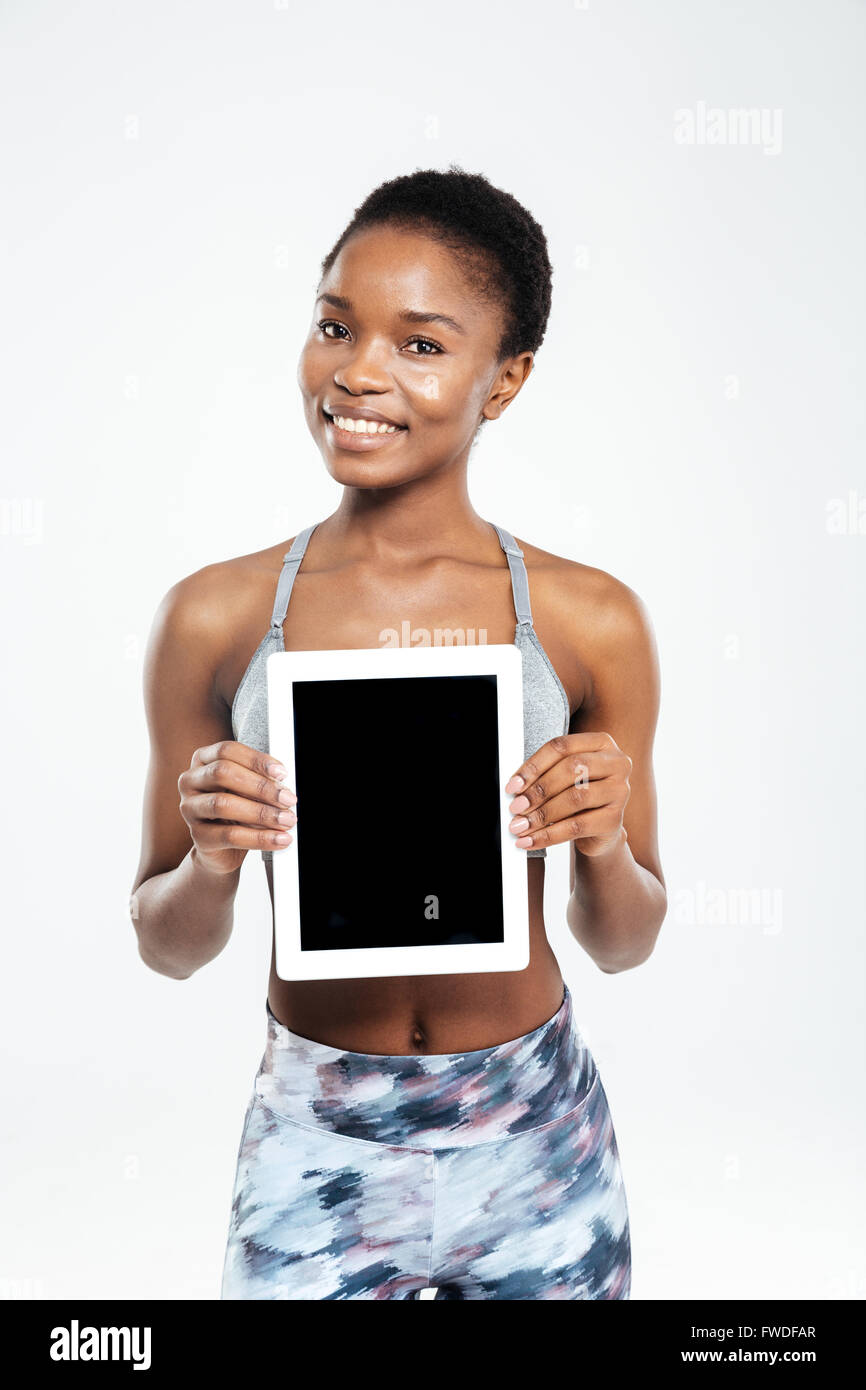 Smiling afro american woman showing blank tablet computer screen ...