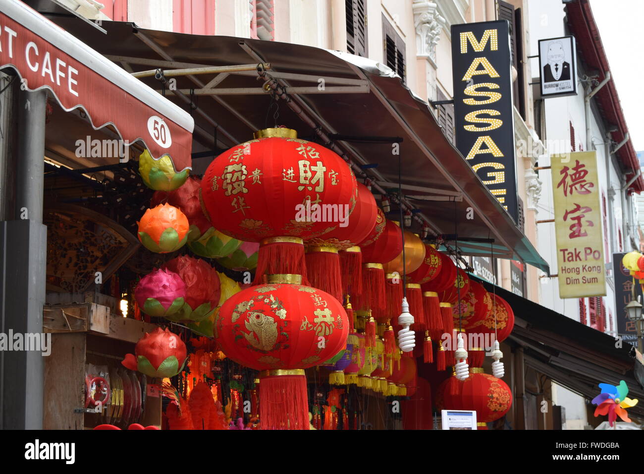Row of Chinese lanterns fronting a massage parlor in Singapore's Chinatown during lunar new year Stock Photo