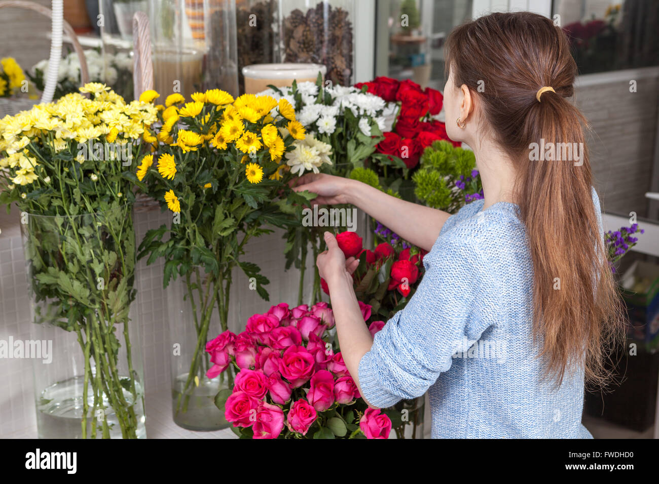 Florist caring for flowers at the shop Stock Photo Alamy
