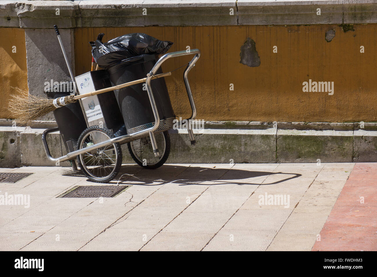 Street sweeper cart in the sun Stock Photo