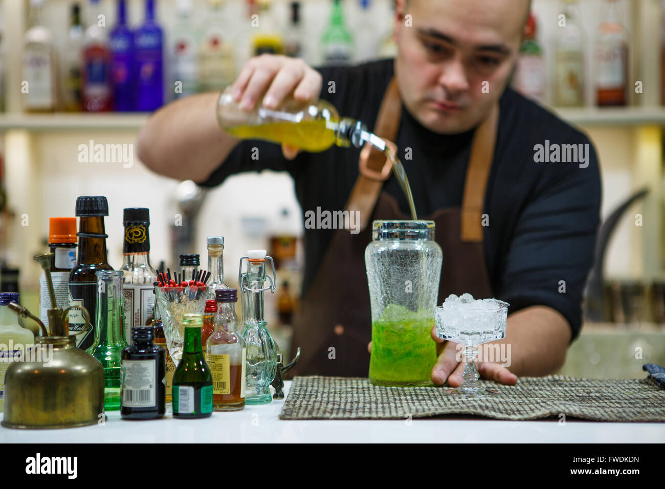 barman pouring a pink cocktail drink Stock Photo
